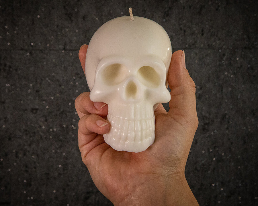 Skull candle scale in hand