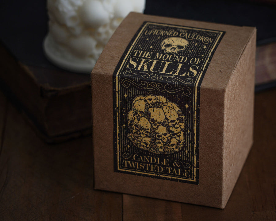 Candle in the shape of a pile of skulls box and gothic label